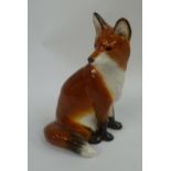A John Beswick figurine of a sitting fox, 14cm high.