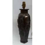 A 20th century Japanese bronze lamp base of hexagonal form, the panels decorated in high relief with