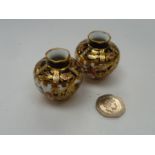 A pair of Royal Crown Derby miniature vases decorated in the Imari palette.