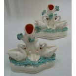 Two Staffordshire pottery swan figure group spill vases.