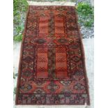 An orange ground geometric patterned woollen rug, 1.4 x 0.66m.