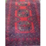 A red ground woollen rug with geometric pattern, 1.8 x 0.93m.