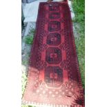 A red ground geometric patterned Bokhara runner, 2.8 x 0.78m.