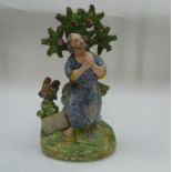 A Staffordshire flat back figure, 'St Peter', with brocage tree, keys, a chicken and bible.