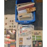 Plastic box of stamps in packets & pages