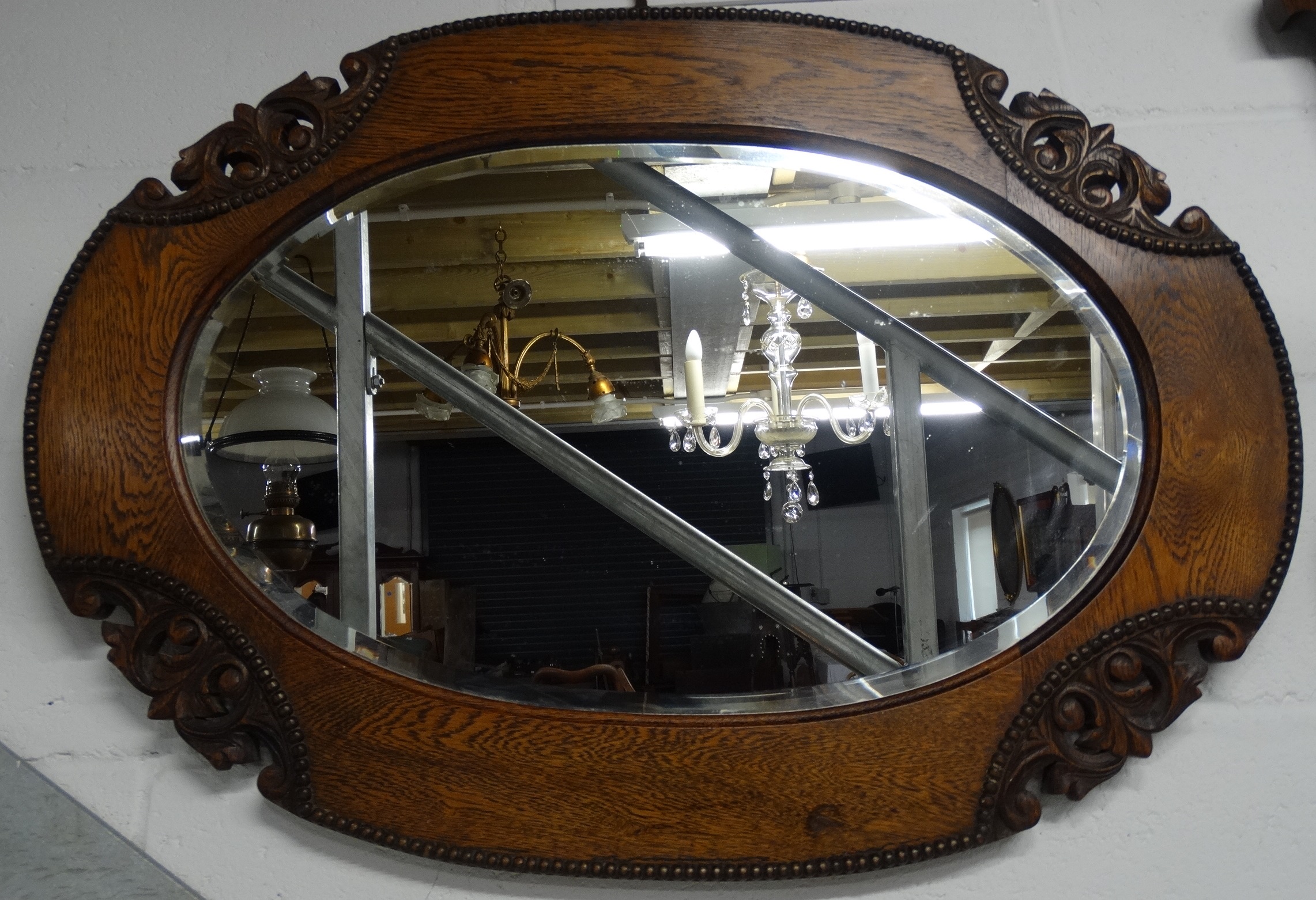 Carved oak framed mirror 33' across