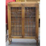 Original oak 1920's book display cabinet with leaded glass doors integral wood shelves on Queen Anne