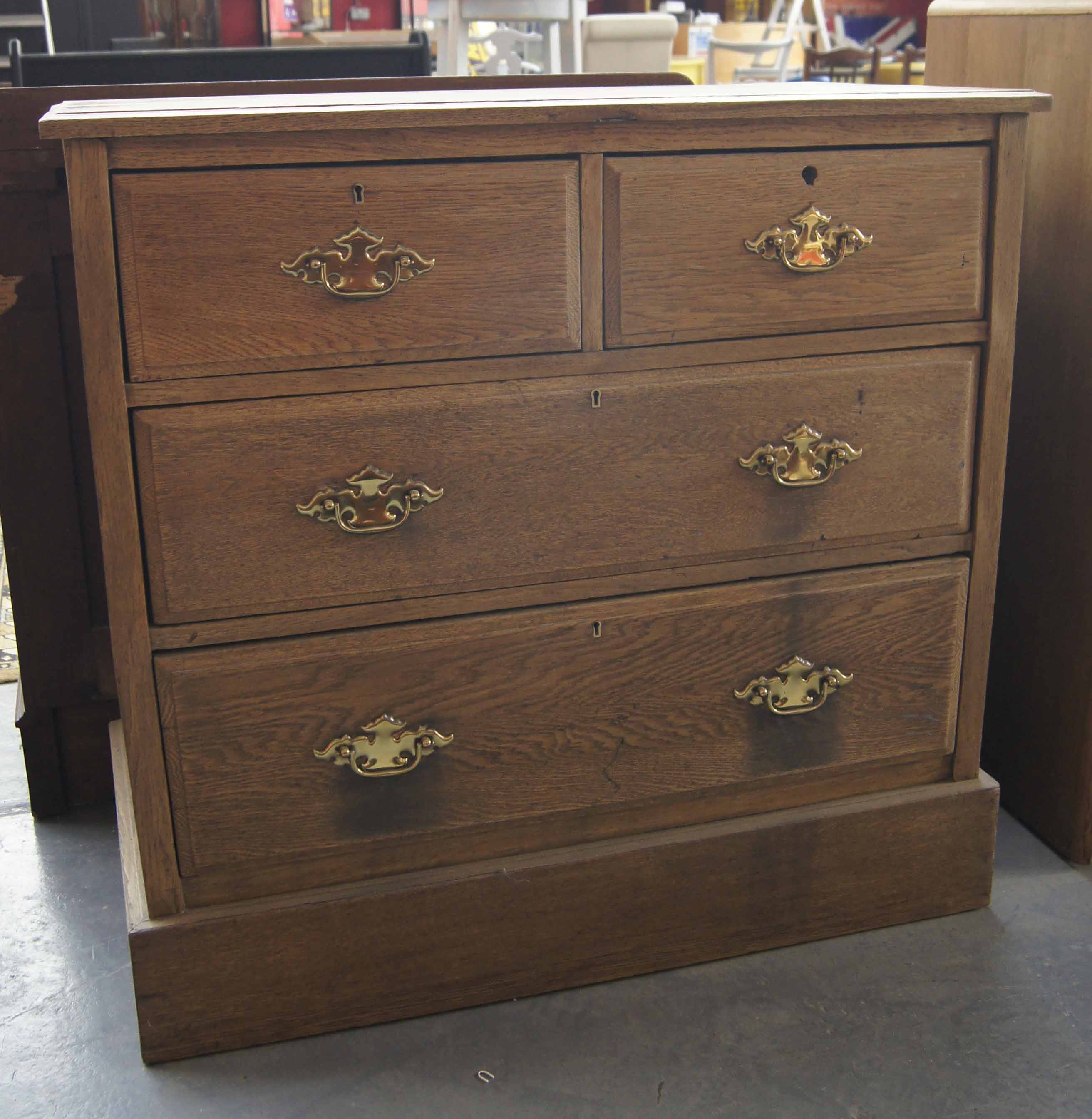 19th c oak two over two chest of drawers with brass drop ring handles on platform base 34ins H x