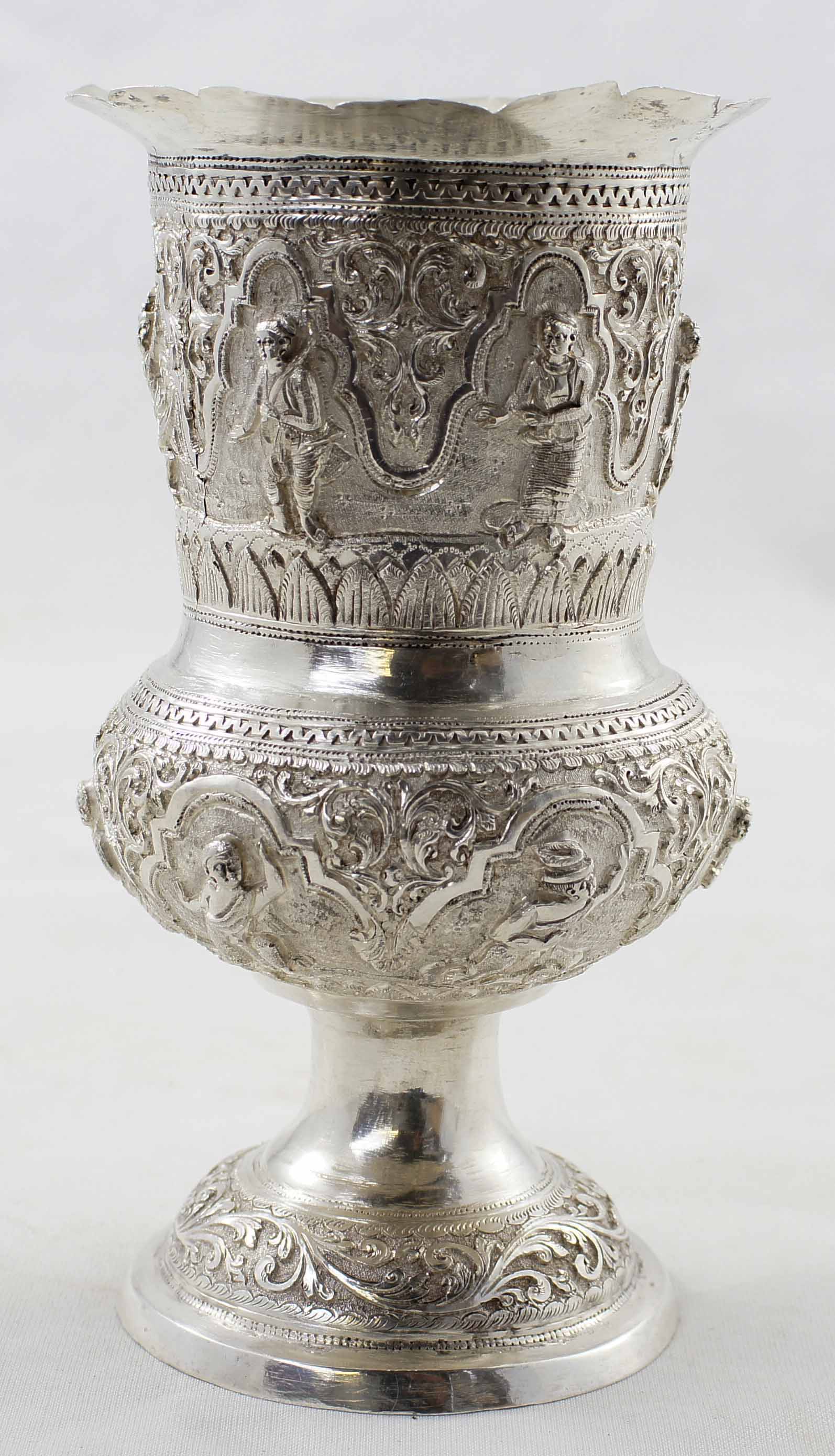 Early Eastern silver goblet with embossed figural deity and warrior relief and foliage scroll