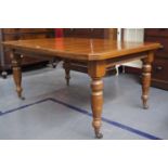 Mid 19th C mahogany wind-out extending dining table on turned legs brass and porcelain castors  Open