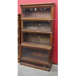 Early 20th c mahogany four tier stepped bookcase with glazed doors with makers plaque marked The