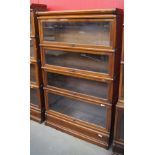Early 20th c mahogany four tier bookcase with glazed doors with makers plaque marked The Globe