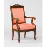 FAUTEUIL, Restoration, France. Mahogany, carved with volutes and stylised leaves. Padded seat and