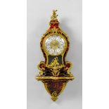 CLOCK ON PLINTH, late Louis XV, France, 19th century. Curved wooden case, decorated with red