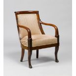 FAUTEUIL, Empire, France. Mahogany, carved with leaves and palmettes. Padded backrest 'en