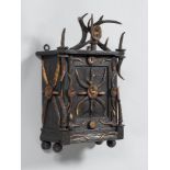 LIQUOR WALL CABINET, in the rustic style. Grained wood, carved, stained and partially decorated with