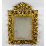 CARVED MIRROR, Baroque style, Italy, 19th century. Wood, carved and gilt. Rectangular frame with