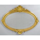 OVAL MIRROR, Louis Philippe, France. Wood and stucco, gilt. Oval frame with flowers, leaves and