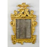 MIRROR, Baroque, Italy. Wood, carved with volutes, leaves and rocailles, and gilt. Rectangular frame