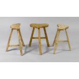 3 STOOLS, in the rustic style. Hardwood. Half-round seat.    3 HOCKER, im rustikalen Stil. Hartholz.