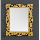 MIRROR, in the Italian Baroque style. Wood, pierced and carved with leaf volutes, and gilt.