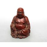Glücksbuddha  Auf rundem Sockel Darstellung des dickbauchigen Buddhas. Hartholz, geschnitzt. H.: