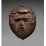 AN IBO MASK  With pierced rectangular mouth, scarification in relief on cheeks and temples, traces