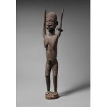 A LOBI FEMALE FIGURE  Standing on domed base with both arms raised above the head, semi-circular