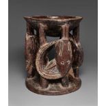A YORUBA IFA BOWL  Agere ifa, the support carved as three coiled mudfish, dark patina. 20 cm. high