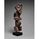 A MAMBILA FIGURE  Standing with the arms in relief against the body the hands held forward, the eyes