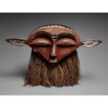 AN EASTERN PENDE MASK  Panya Ngombe, the wide face with broad slit eyes and small rectangular mouth,