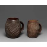 TWO KUBA CUPS  Each of barrel form with carved geometric motifs and loop handle, dark glossy