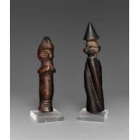 TWO YAKA AMULETS  One a mbwoolo figure with spiral body and conical headgear; the other a small