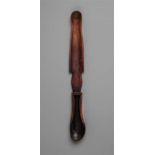 AN AFRICAN SPOON  The shaped handle of bevelled form, the shaped bowl with black oily patina. 47.5