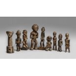 NINE MBALA POWER FIGURES One with Janus head on cylindrical base, the others each carved as a