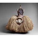 A YAKA MASK The small face with large upturned nose and set within arched frame, the conical