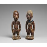 A PAIR OF YORUBA TWIN FIGURES Ere ibeji, male and female, the male with head shaved about the