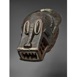 A BAULE BUFFALO MASK Bo nun amuin, with large oval eyes, the rectangular jaws with carved teeth, the