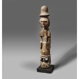 AN ORON FIGURE The spherical head with long cross-hatched beard, scarification on temples, wearing