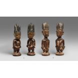 A PAIR OF YORUBA TWIN FIGURES Male and female, each with the blackened coiffure in five incised