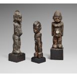 THREE LOBI FIGURES Each standing with arms in relief to the sides, dark and encrusted patinas, one