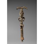 A YORUBA BRONZE SHANGO STAFF Cast as a kneeling female figure holding her breasts, curved forked