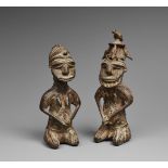 A PAIR OF YORUBA BRASS ONILE FIGURES Male and female, each kneeling with the hands joined on the lap