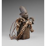 A YORUBA CULT FIGURE The rectangular grooved body with motifs in relief representing stylised dolls,