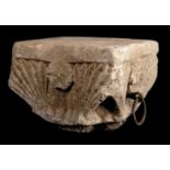 Limestone capital decorated with four flowers and leaves and two wrought iron rings.  Catalonia.