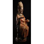 "Bishop". Carved, gilt and polychrome sculpture chiefly in orange, ochre, green and black tones.