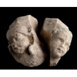 Two limestone putti heads which came from small columns.  Gothic.  Circa 1340.  Some damage.