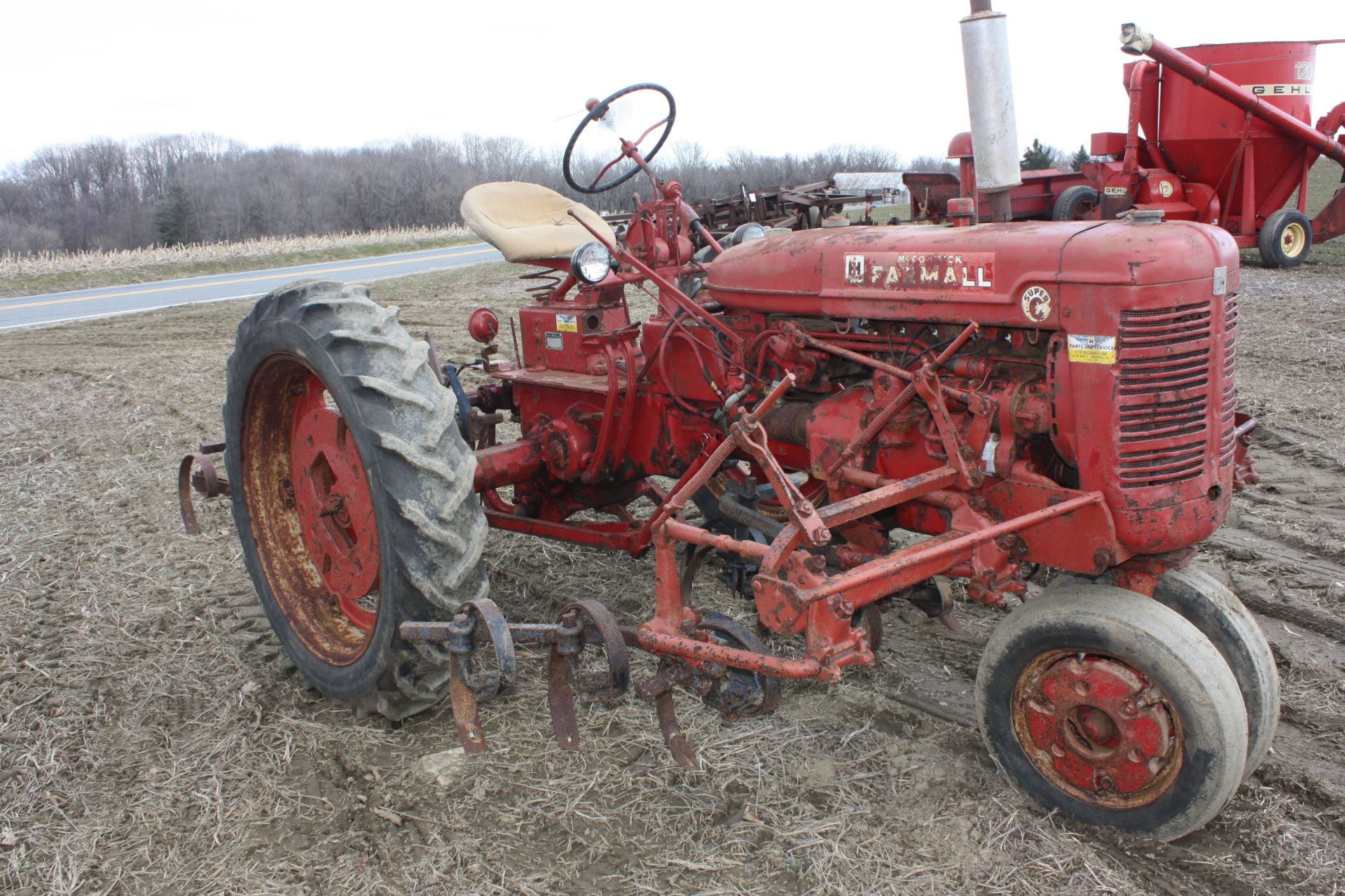 Farmall Super C with fast hitch and selling with a complete set of  Cultivators , Paint is fair.