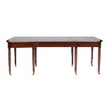 A GEORGE III MAHOGANY SECTIONAL DINING TABLE The D ends fitted with central... A GEORGE III MAHOGANY