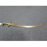 Indian Tulwar. Curved blade 28" approx. Brass hilt with rams head pommel. Crossguard with brass head